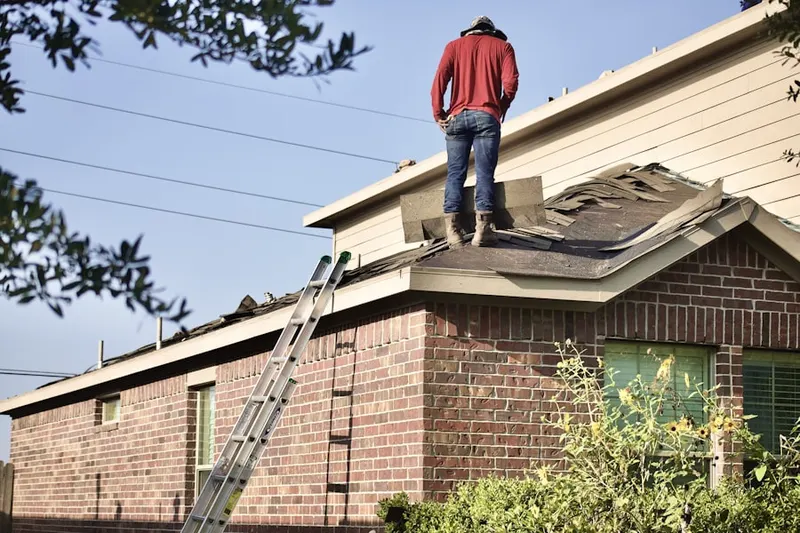 Professional roofer working on a residential roof in Jones Farm